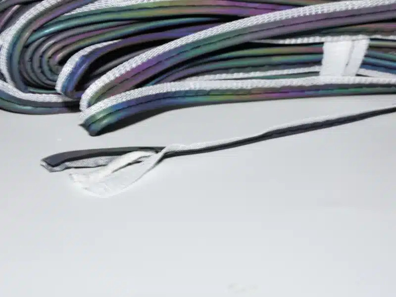 Close view of MP0103 piping ends and narrow multicolored edges beside a folded bundle