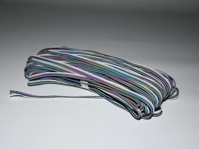 Bundle of dark MP0103 piping with multicolored highlights on the raised edges
