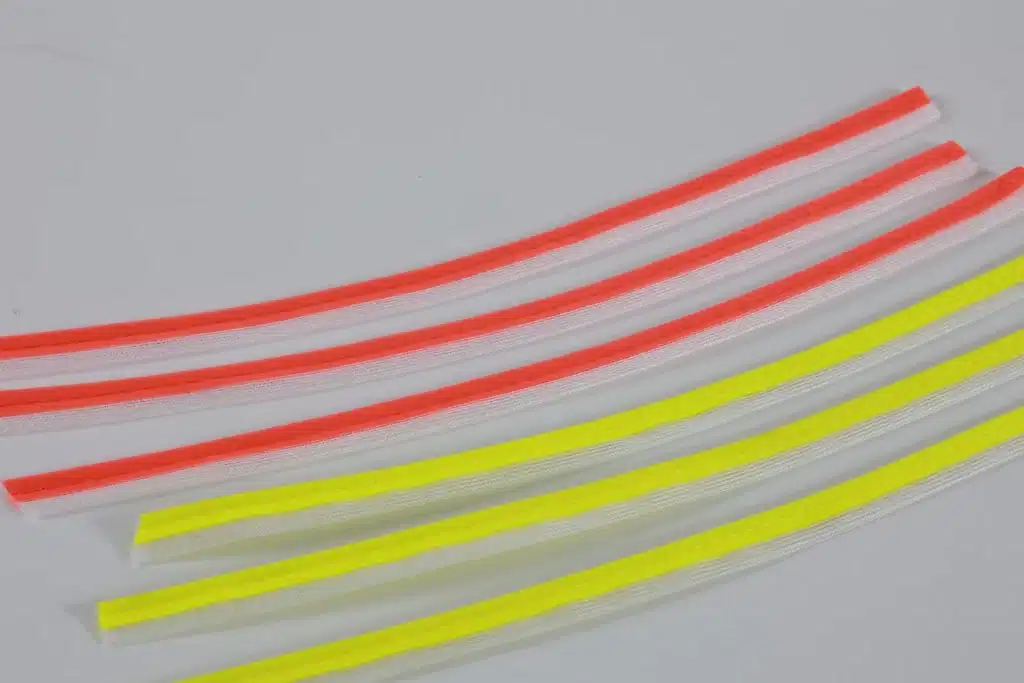 Parallel gray piping strips with orange and yellow flanges