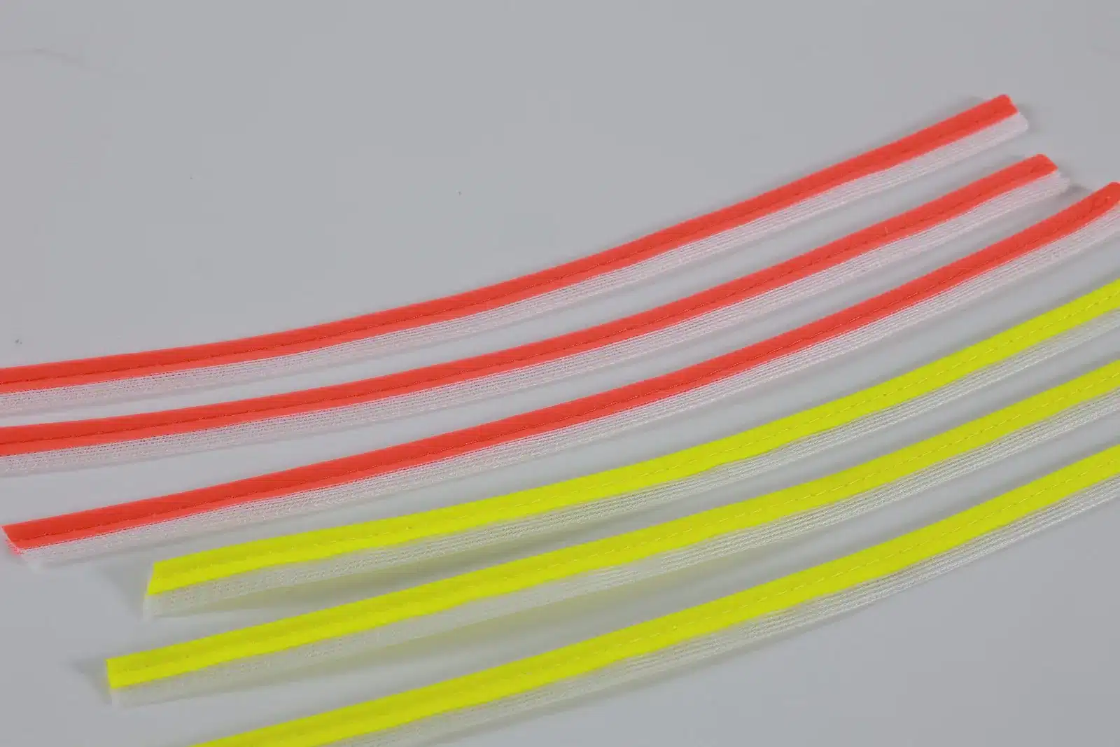 Parallel gray piping strips with orange and yellow flanges for specification review in reflective piping lead time planning