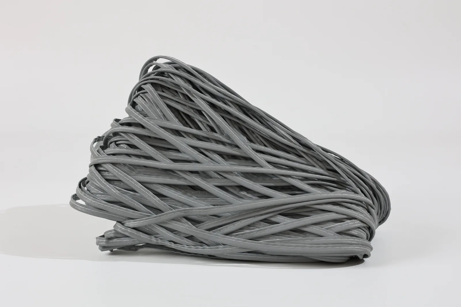 Bundle of gray MP0104 piping on a light background